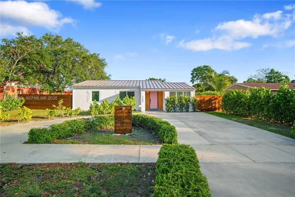 a front view of a house with garden