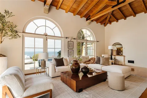 a dining room with furniture a chandelier and wooden floor