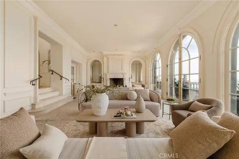 a living room with furniture fireplace and a large window