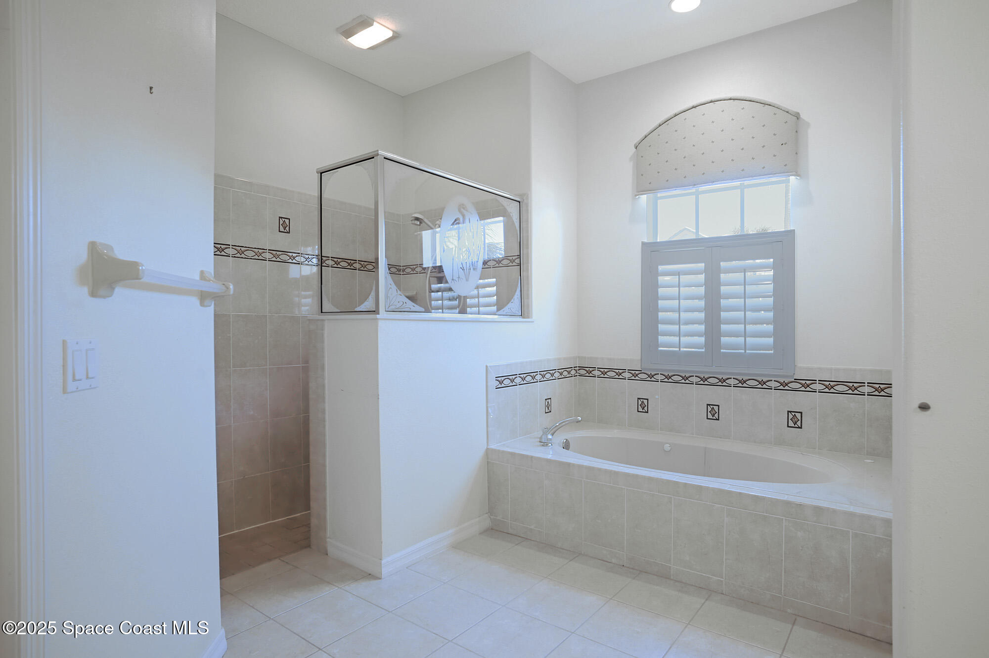 5357 Solway Drive Melbourne Beach, FL 32951 - Photo 12 of 31 a bathroom with a bathtub and a shower
