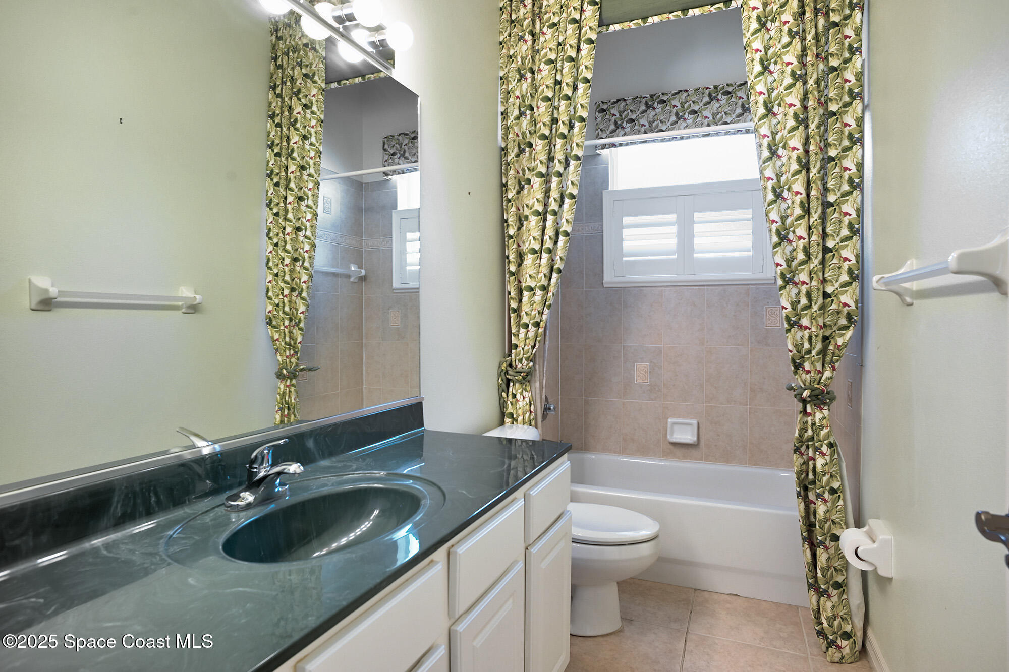 5357 Solway Drive Melbourne Beach, FL 32951 - Photo 14 of 31 a bathroom with a granite countertop sink toilet and shower