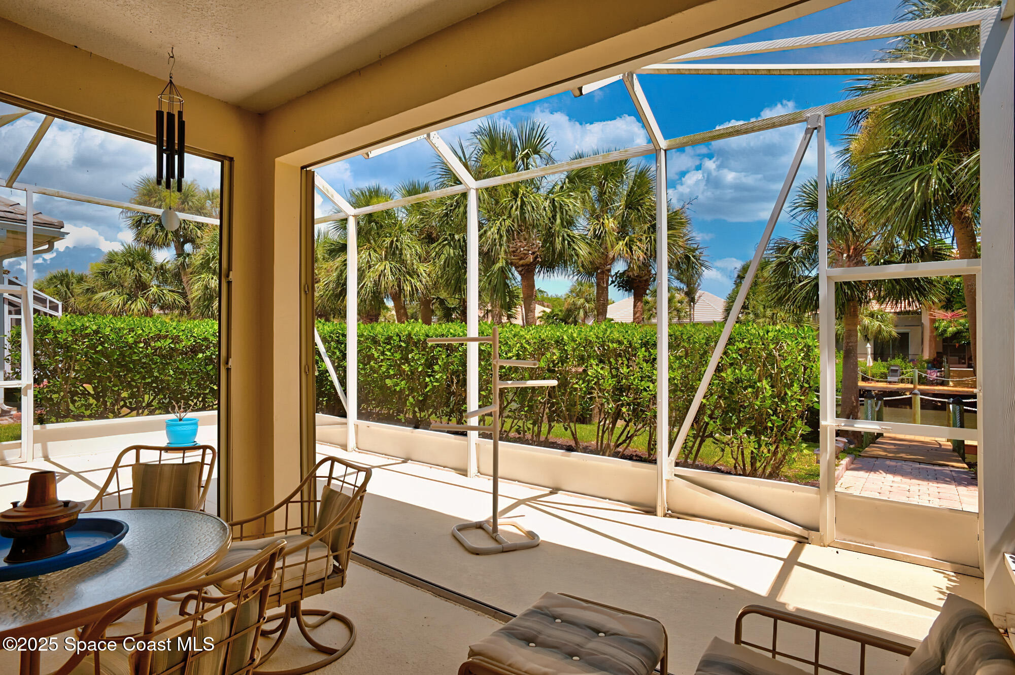 5357 Solway Drive Melbourne Beach, FL 32951 - Photo 16 of 31 a view of a patio with table and chairs and potted plants