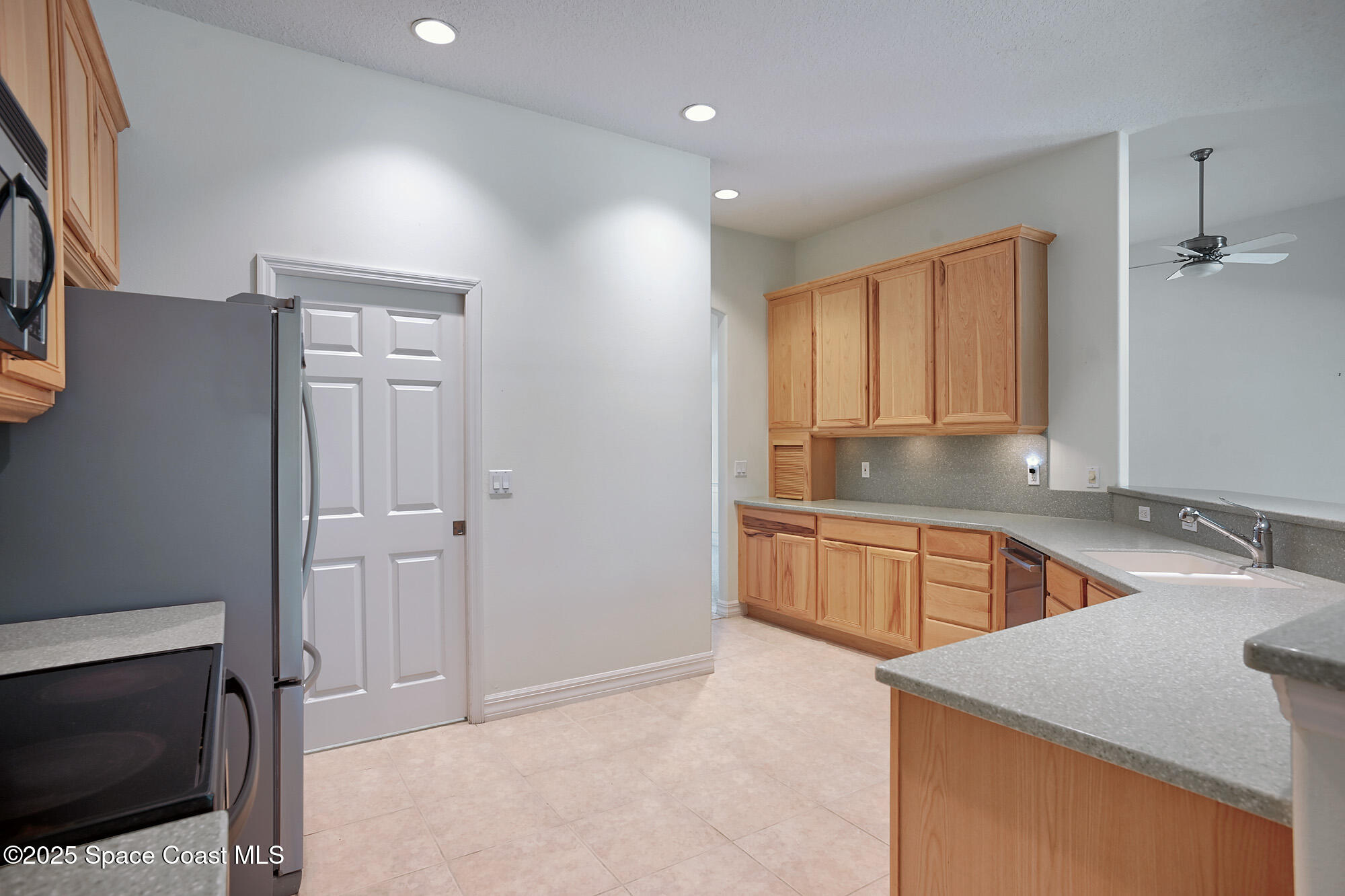 5357 Solway Drive Melbourne Beach, FL 32951 - Photo 3 of 31 a kitchen with stainless steel appliances granite countertop a sink and a granite counter tops