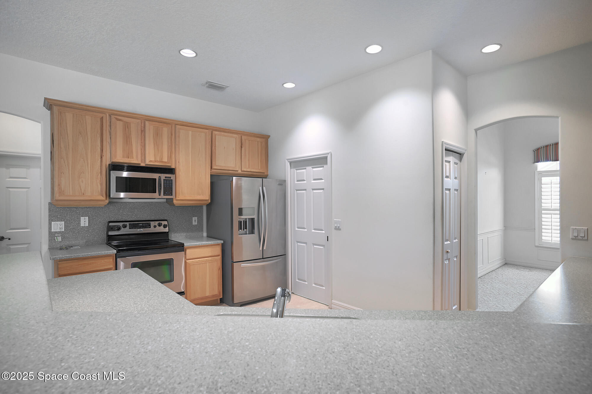 5357 Solway Drive Melbourne Beach, FL 32951 - Photo 4 of 31 a kitchen with stainless steel appliances granite countertop a refrigerator and a stove top oven