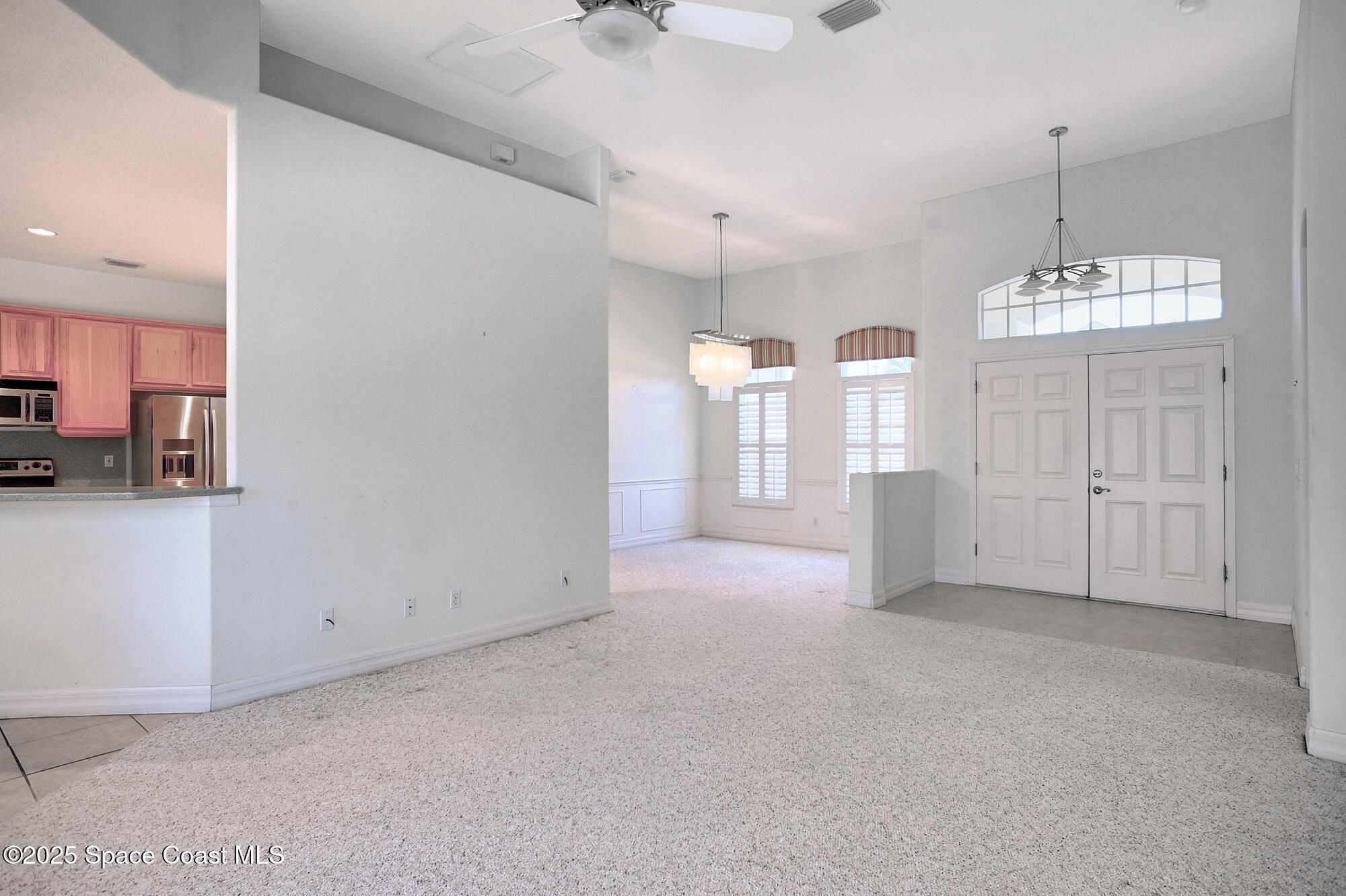 5357 Solway Drive Melbourne Beach, FL 32951 - Photo 5 of 31 a view of a kitchen with refrigerator and window
