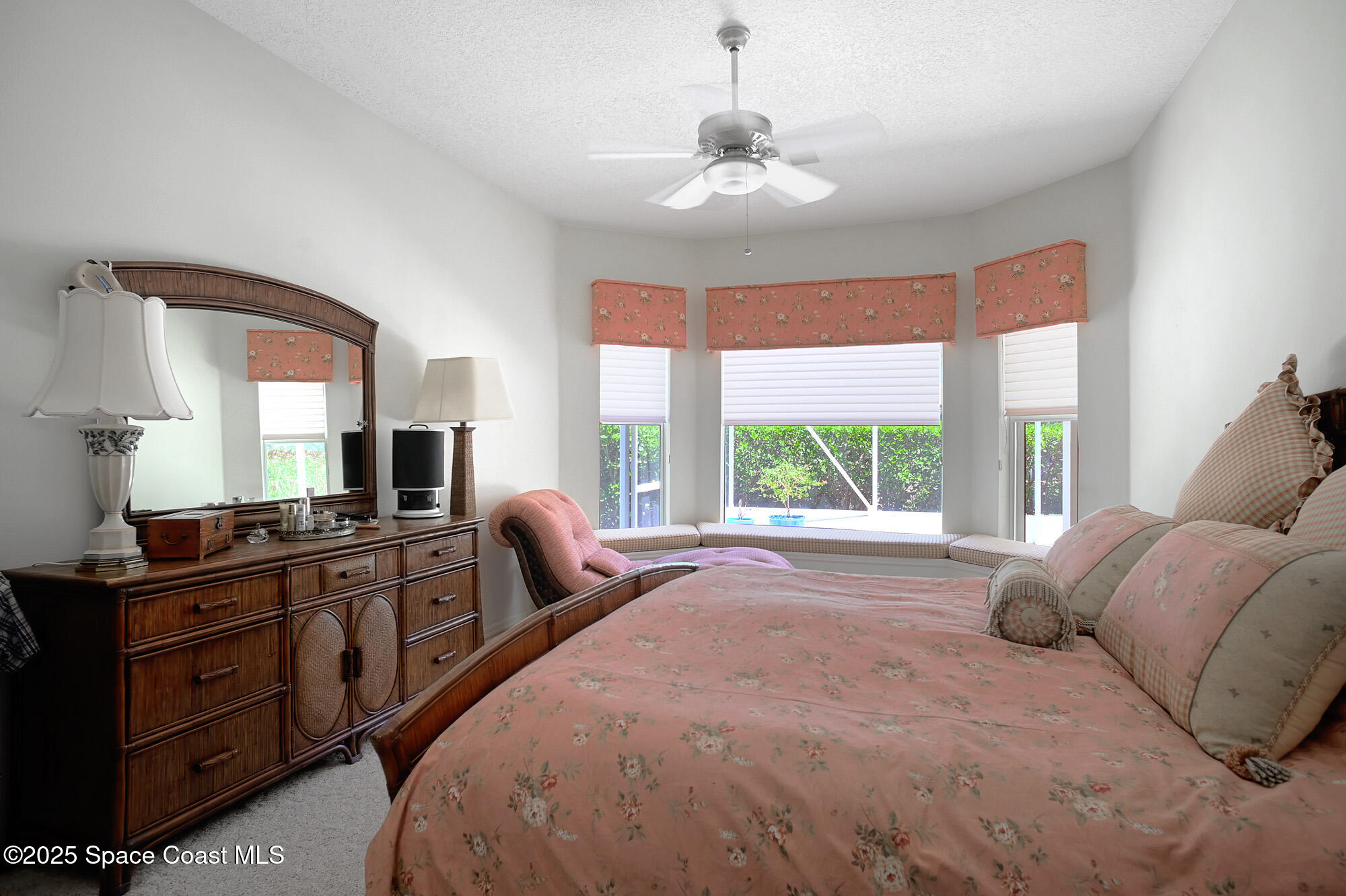 5357 Solway Drive Melbourne Beach, FL 32951 - Photo 10 of 31 a spacious bedroom with a large bed and a large window