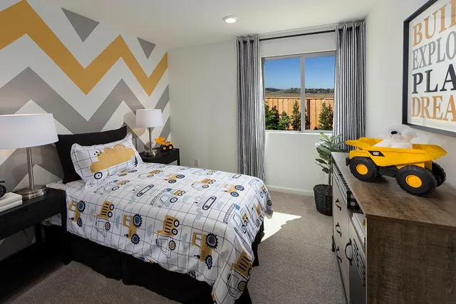 a bedroom with a bed and dresser