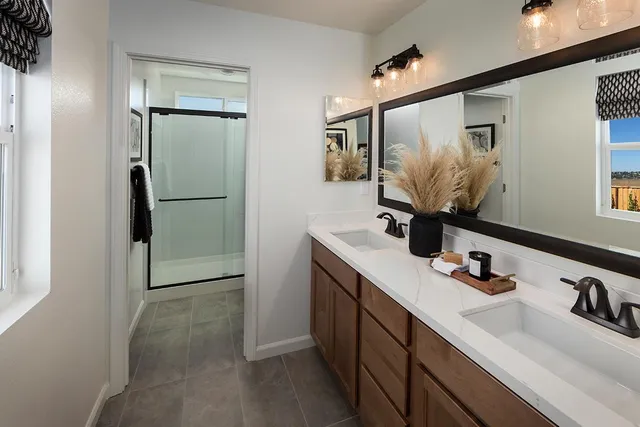 a bathroom with a double vanity sink and mirror