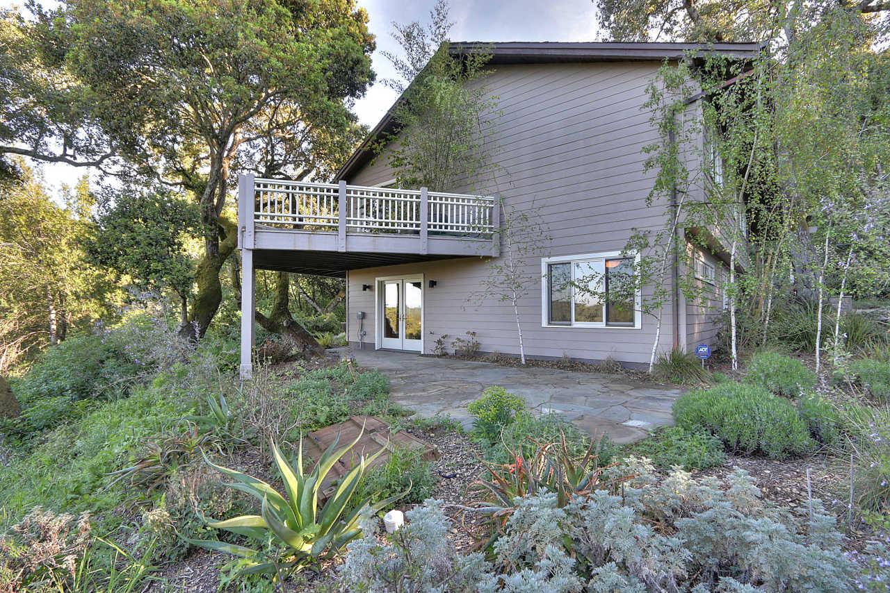 33 Montecito Road Woodside, CA 94062 - Photo 24 of 70 a view of a brick house with large trees next to a road