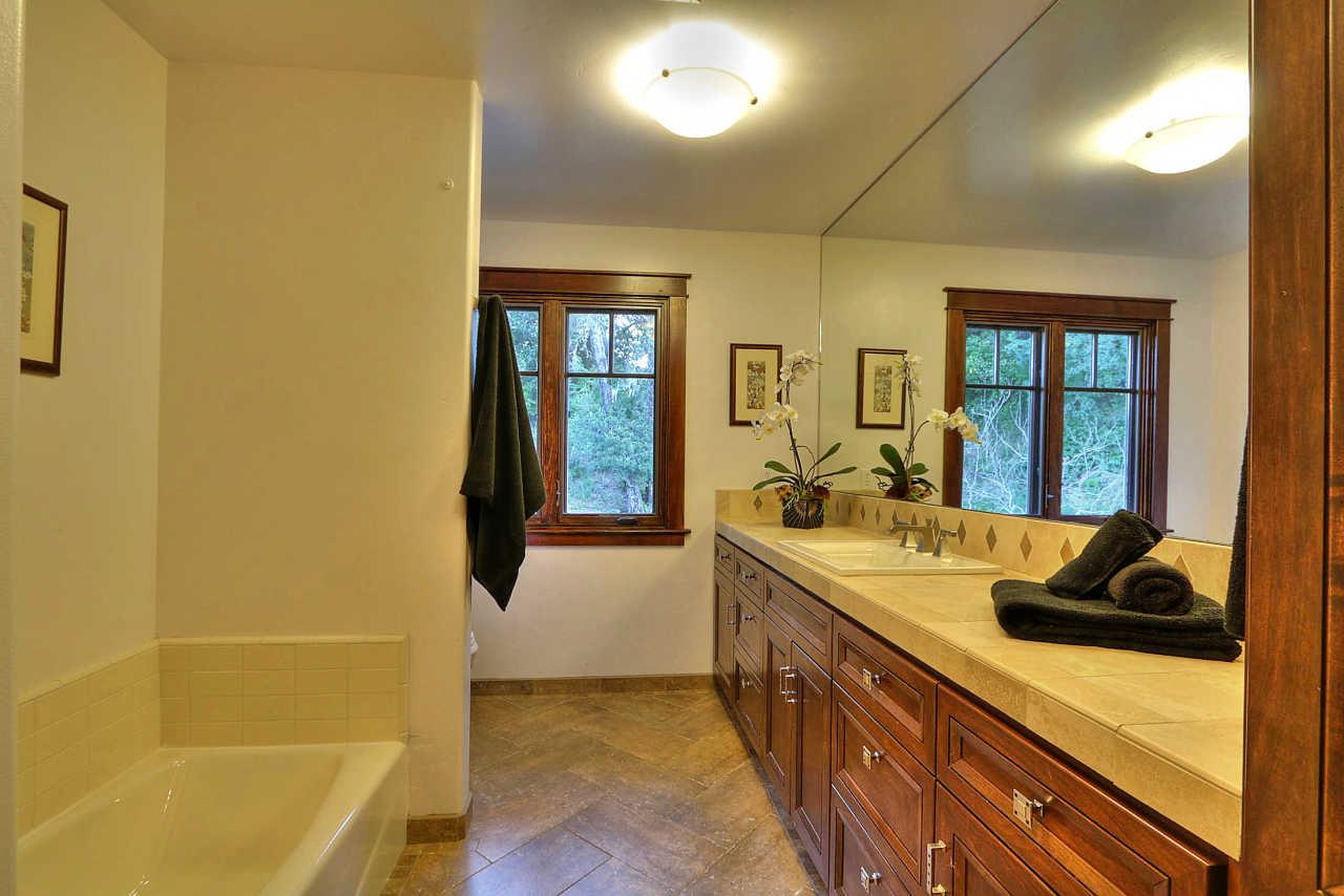 33 Montecito Road Woodside, CA 94062 - Photo 47 of 70 a bathroom with a tub sink and mirror
