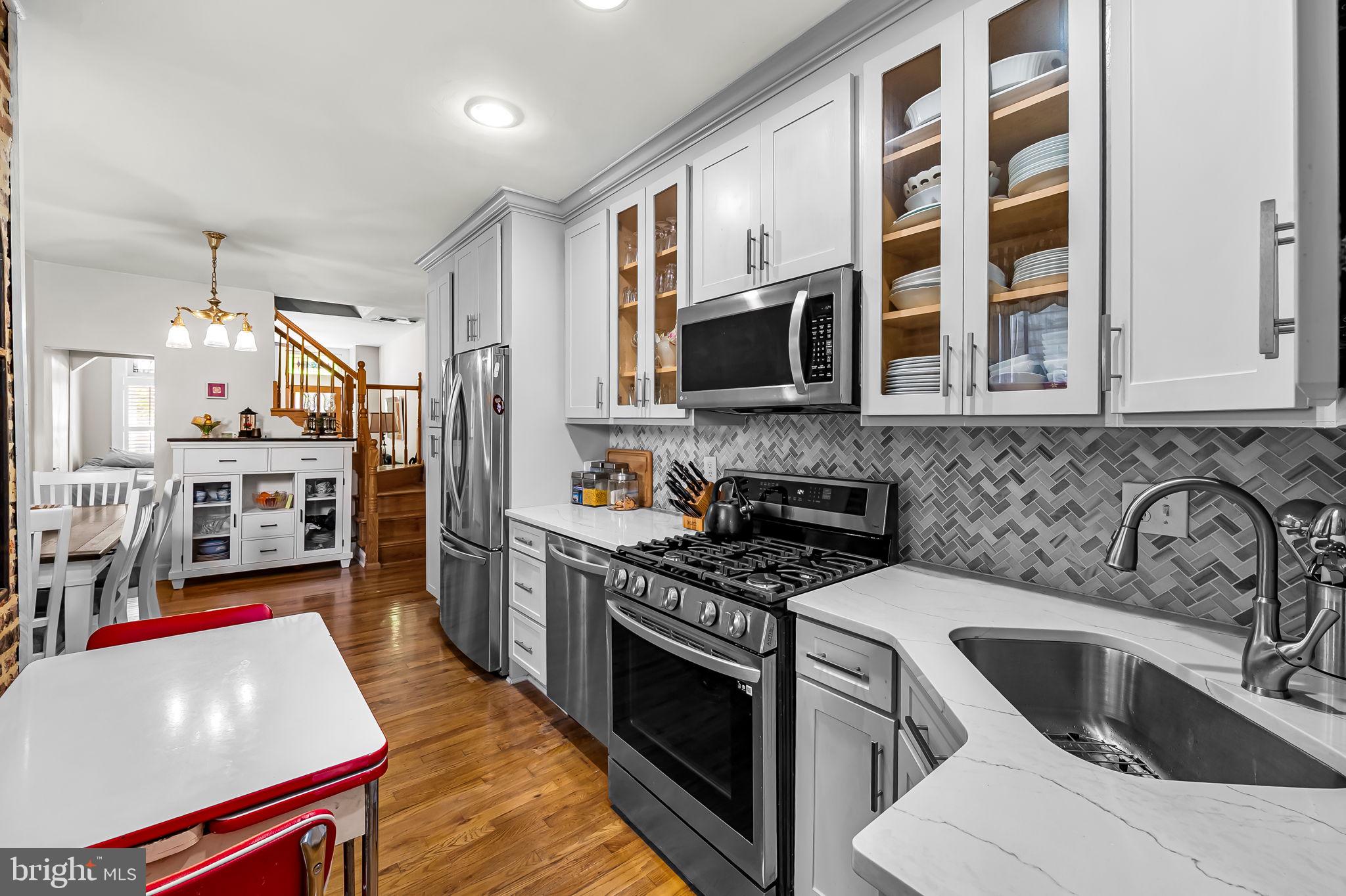 3134 Elliott Street Baltimore, MD 21224 - Photo 13 of 34 a kitchen with stainless steel appliances a stove a sink and a microwave