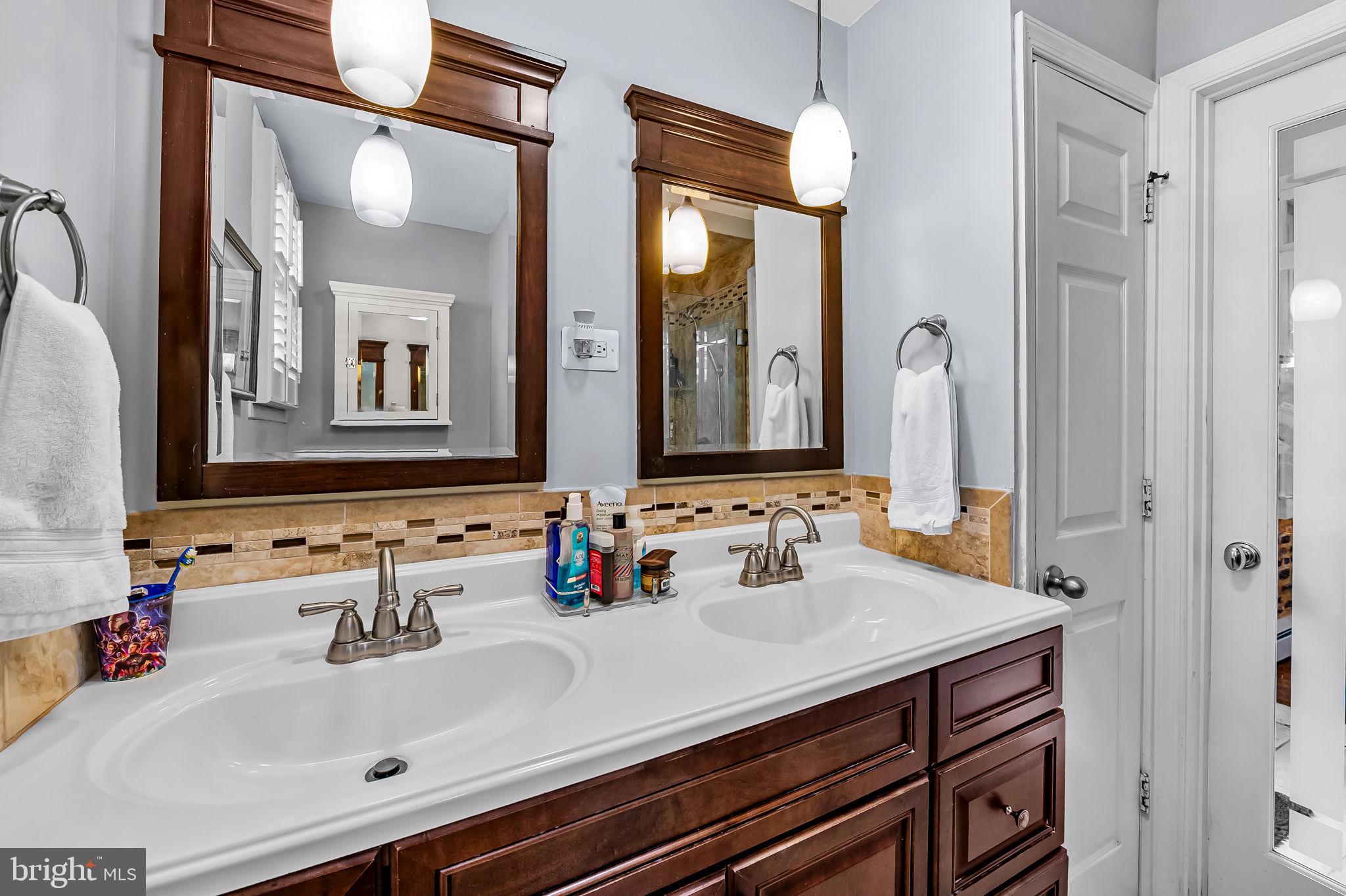 3134 Elliott Street Baltimore, MD 21224 - Photo 16 of 34 a bathroom with a sink and a mirror