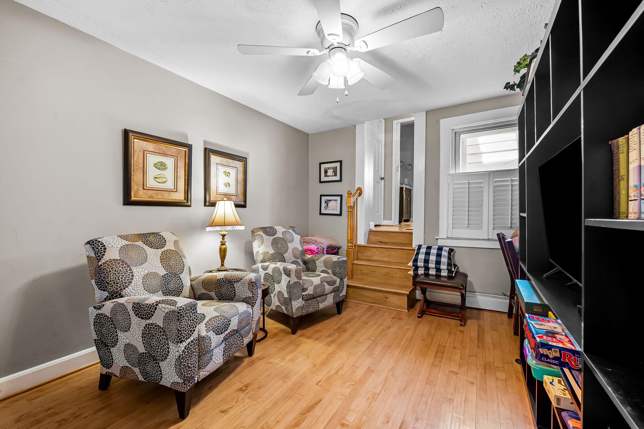 3134 Elliott Street Baltimore, MD 21224 - Photo 18 of 34 a living room with furniture flat screen tv and hard wood flooring
