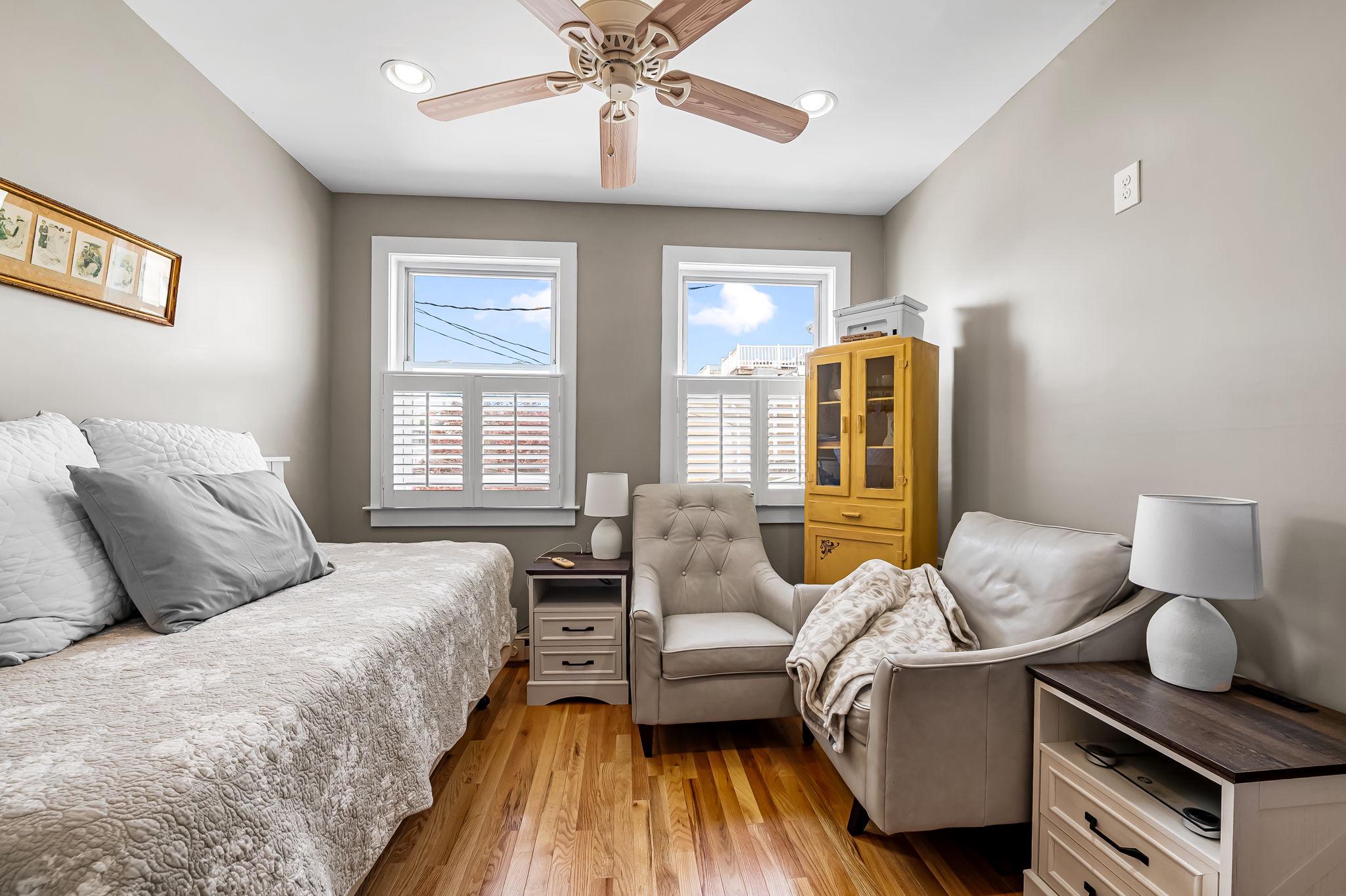 3134 Elliott Street Baltimore, MD 21224 - Photo 22 of 34 a bedroom with a bed and wooden floor