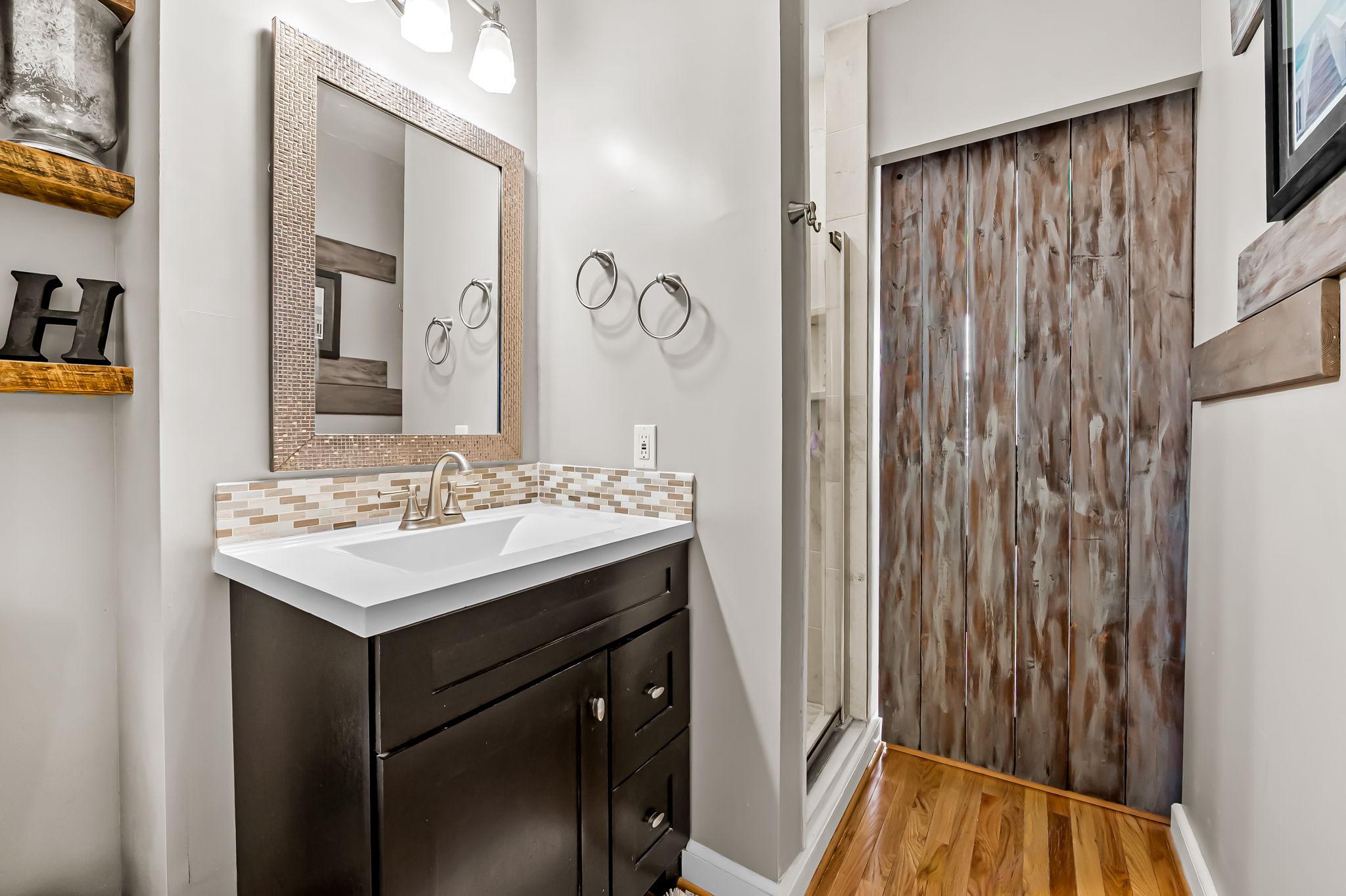 3134 Elliott Street Baltimore, MD 21224 - Photo 24 of 34 a bathroom with a sink vanity and a mirror