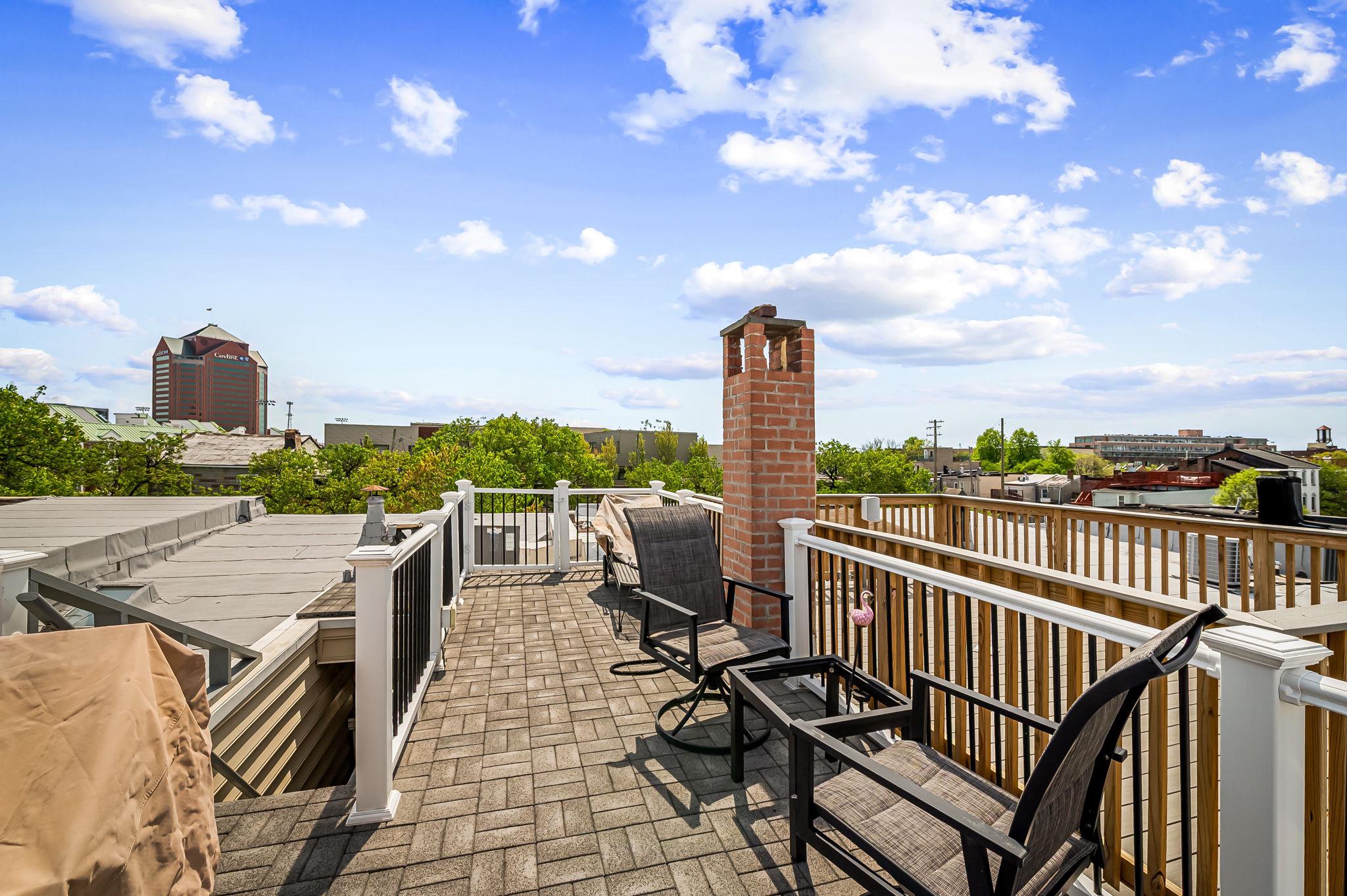 3134 Elliott Street Baltimore, MD 21224 - Photo 25 of 34 a view of a roof deck with table and chairs