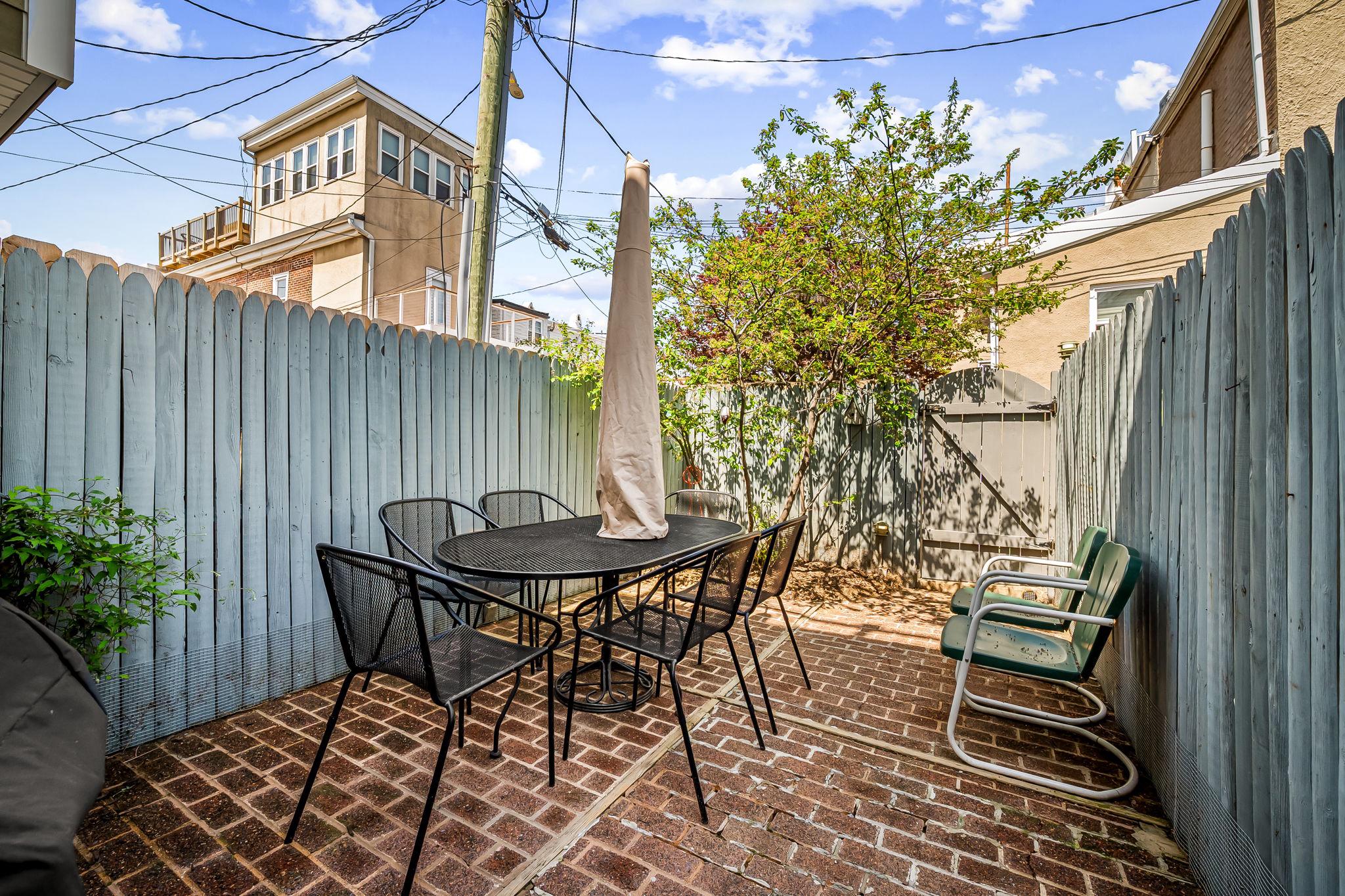 3134 Elliott Street Baltimore, MD 21224 - Photo 28 of 34 a backyard of a house with table and chairs