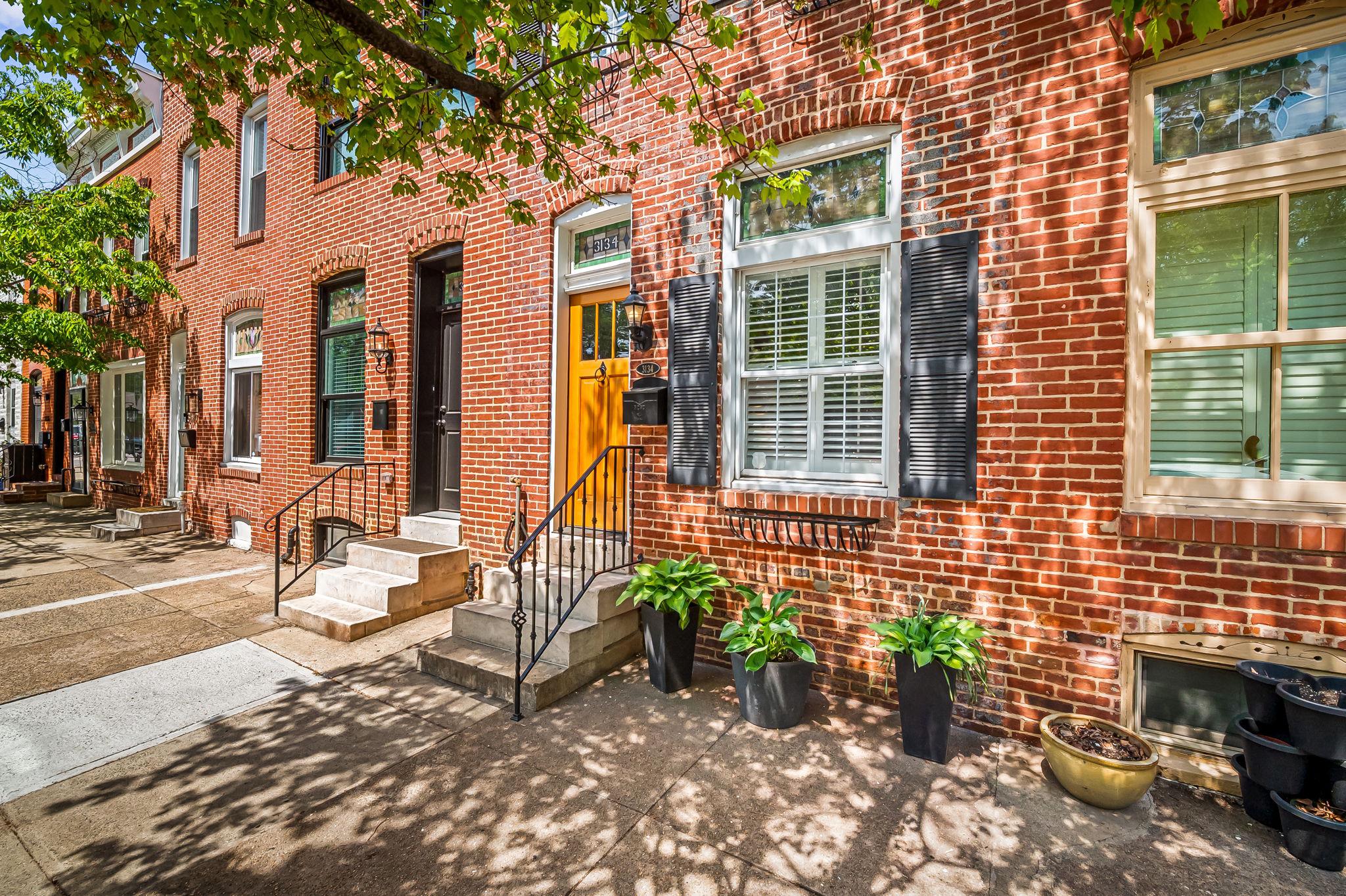 3134 Elliott Street Baltimore, MD 21224 - Photo 4 of 34 a front view of a house with outdoor seating