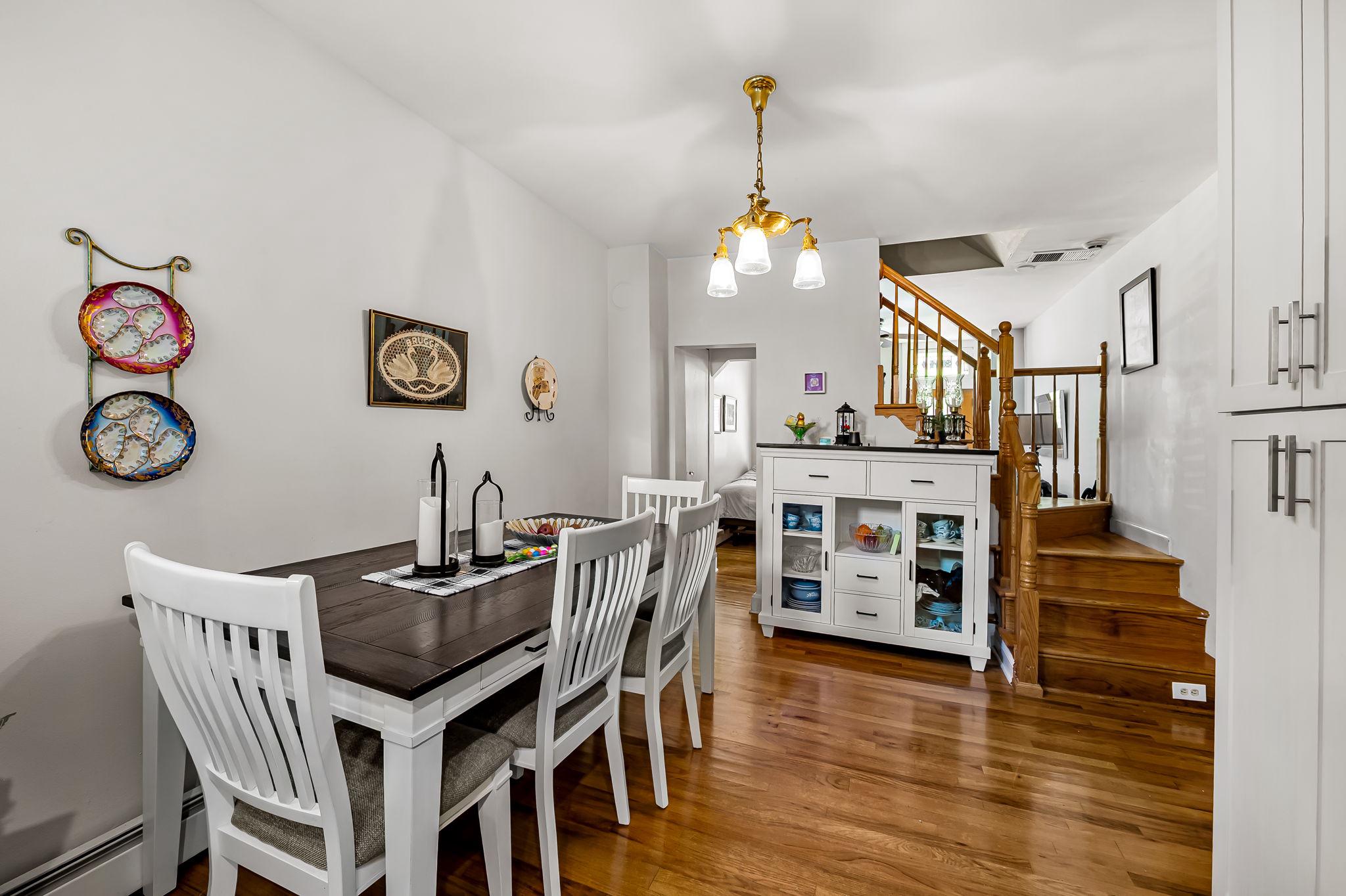 3134 Elliott Street Baltimore, MD 21224 - Photo 8 of 34 a view of a dining room and livingroom with furniture wooden floor a chandelier
