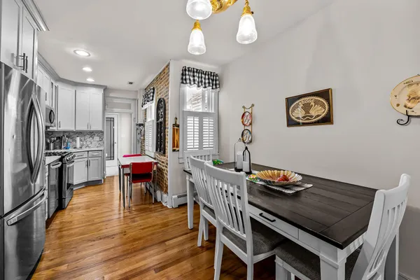 a kitchen with a table chairs and refrigerator