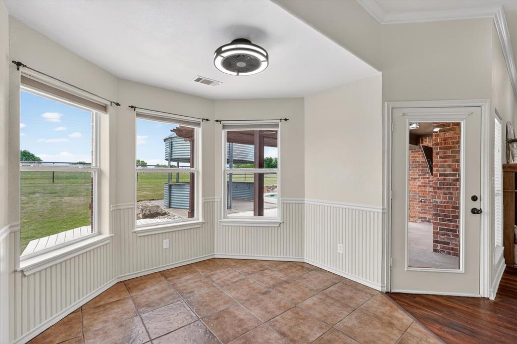2828 Bennett Road Howe, TX 75459 - Photo 8 of 39 a view of an empty room with a window and wooden floor
