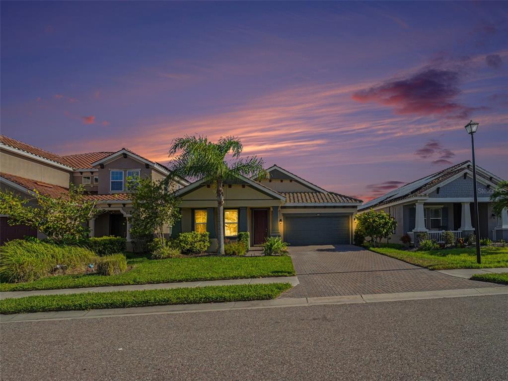 4429 Conchfish Lane Osprey, FL 34229 - Photo 2 of 20 a front view of a house with a yard and potted plants