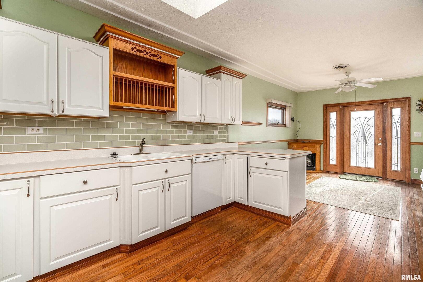 311 Baggott Street Zeigler, IL 62999 - Photo 15 of 38 a kitchen with granite countertop white cabinets and white appliances