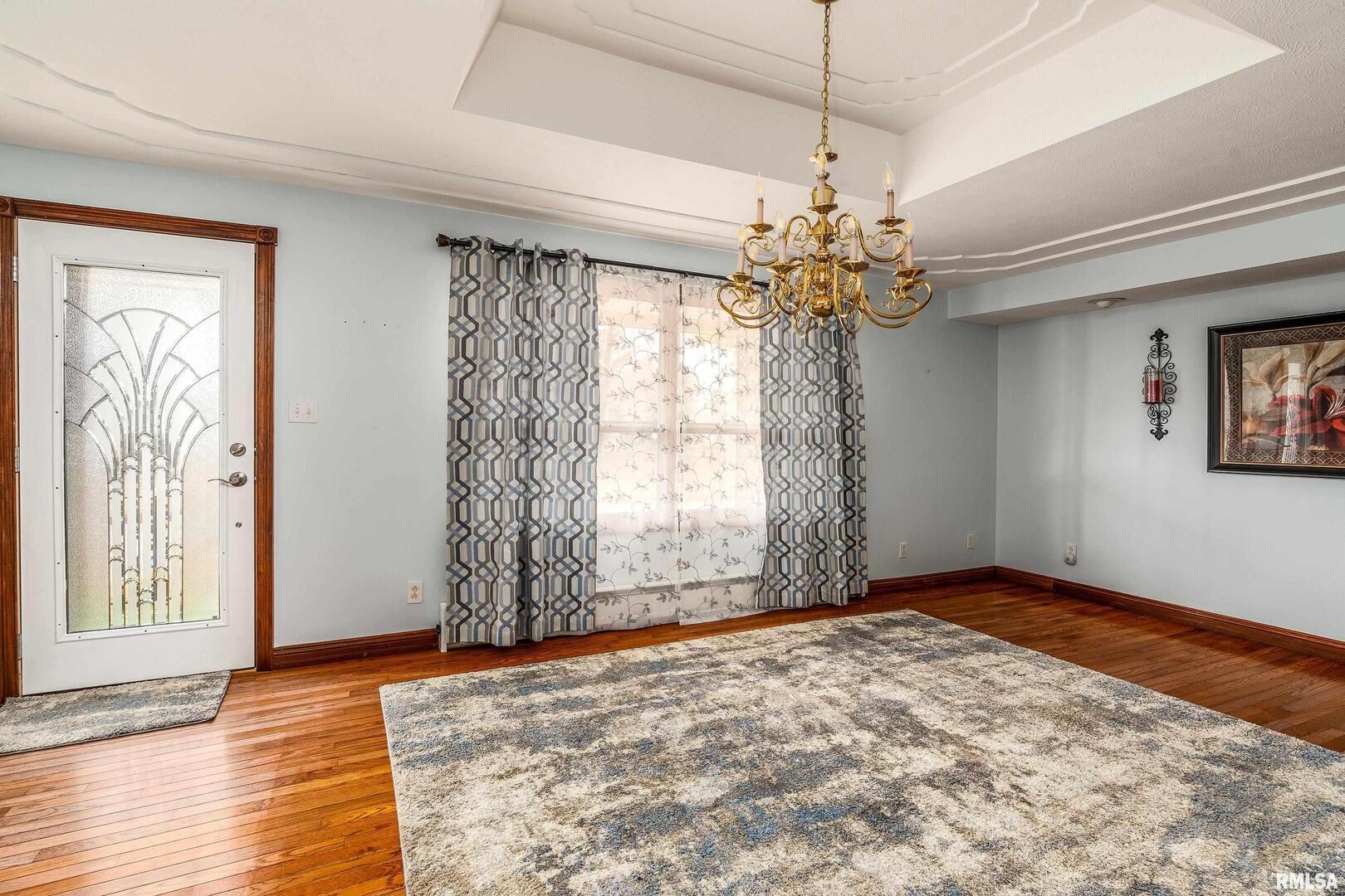 311 Baggott Street Zeigler, IL 62999 - Photo 16 of 38 a view of a livingroom with a chandelier fan and wooden floor