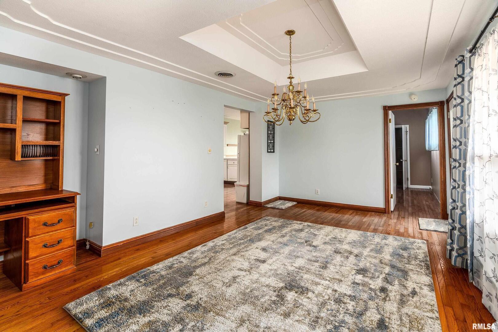 311 Baggott Street Zeigler, IL 62999 - Photo 17 of 38 a view of a livingroom with a chandelier fan and wooden floor