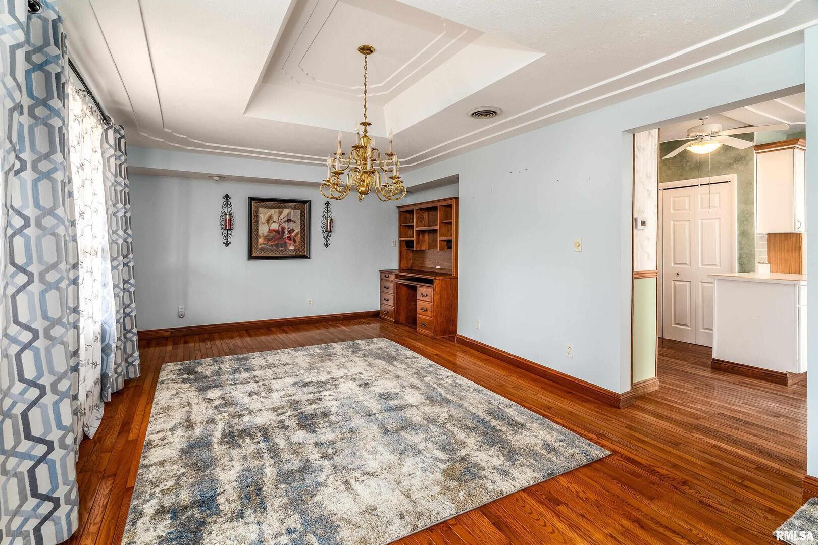 311 Baggott Street Zeigler, IL 62999 - Photo 18 of 38 a view of an empty room and kitchen with wooden floor