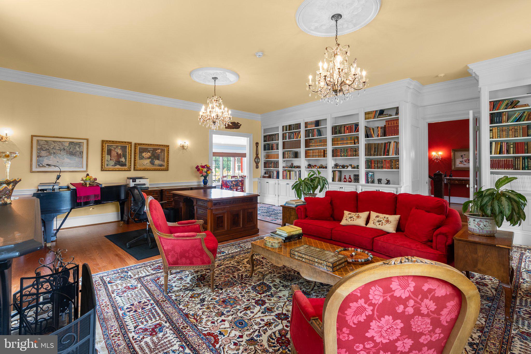 15407 Dr Bowen Road Aquasco, MD 20608 - Photo 25 of 89 a living room with furniture a chandelier and a fireplace