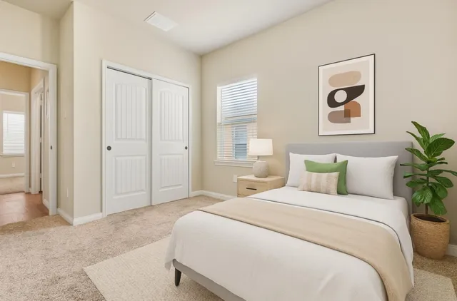 a bedroom with a bed and painting on the wall