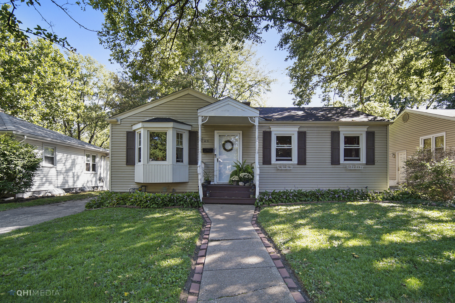 a front view of a house with a garden
