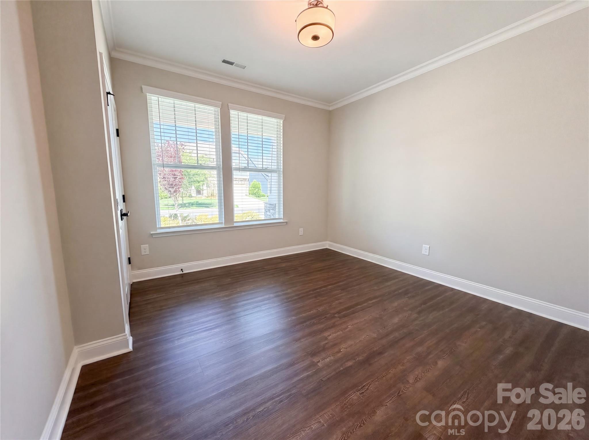 1321 Fishing Creek Road Clover, SC 29710 - Photo 9 of 19 an empty room with wooden floor and windows