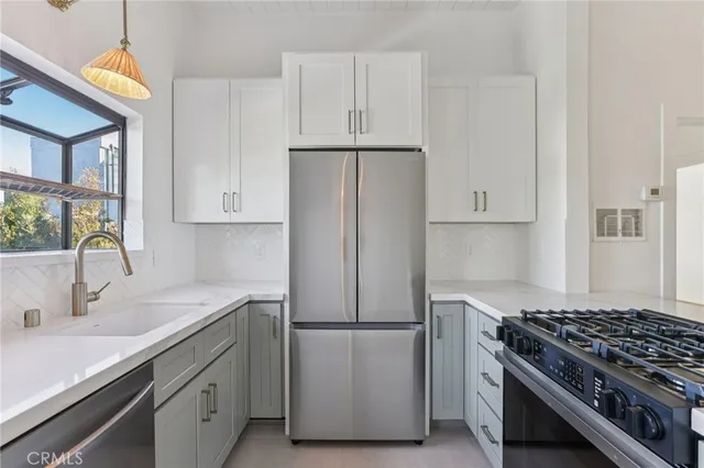 a kitchen with a stove and a wooden floor