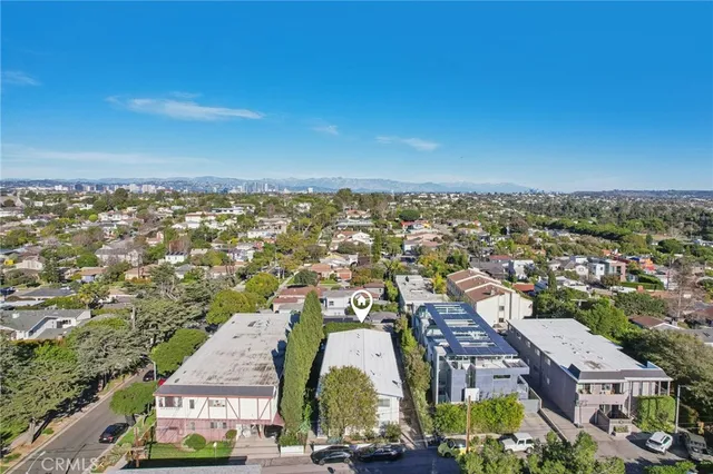 an aerial view of residential houses with city view