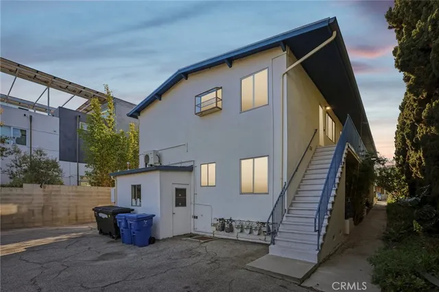 a couple of cars parked in front of a house