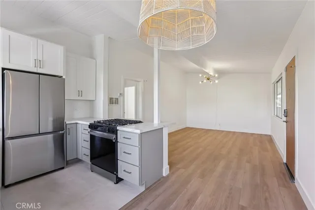 a kitchen with a white cabinets and white appliances