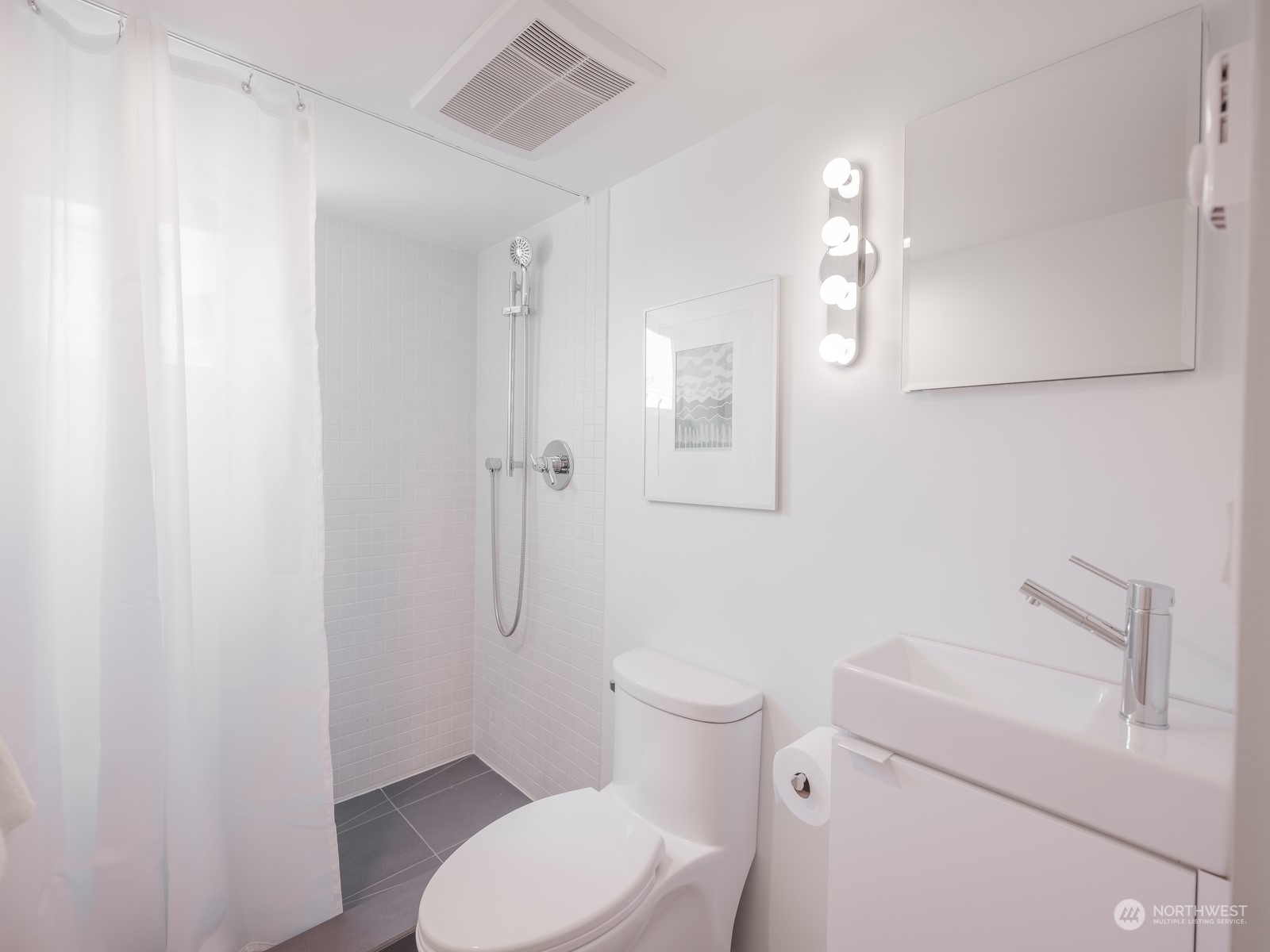 117 East Allison Street Seattle, WA 98102 - Photo 30 of 38 a white toilet sitting next to a bathroom sink and vanity