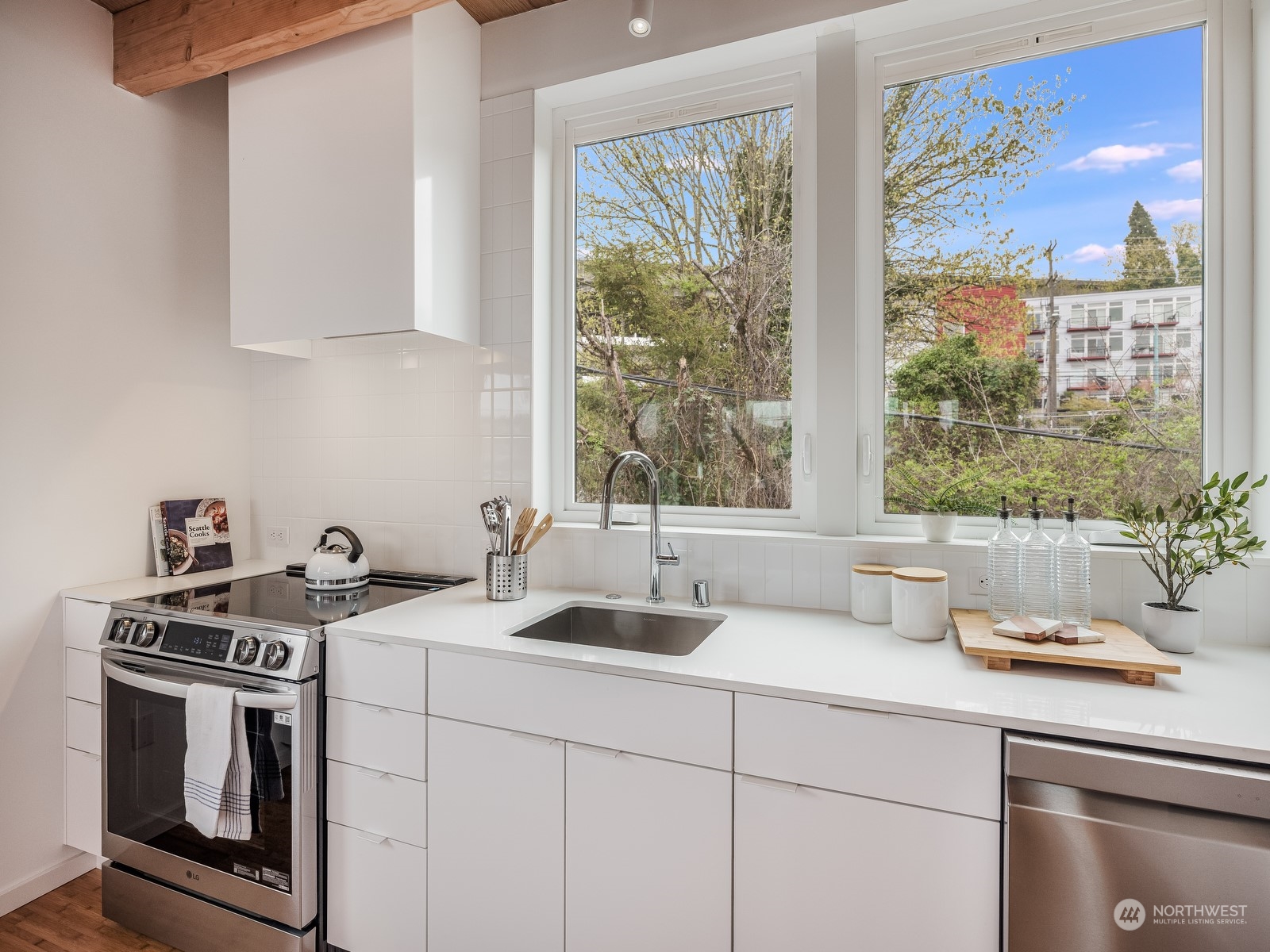 117 East Allison Street Seattle, WA 98102 - Photo 8 of 38 a kitchen with a sink and a stove next to a window