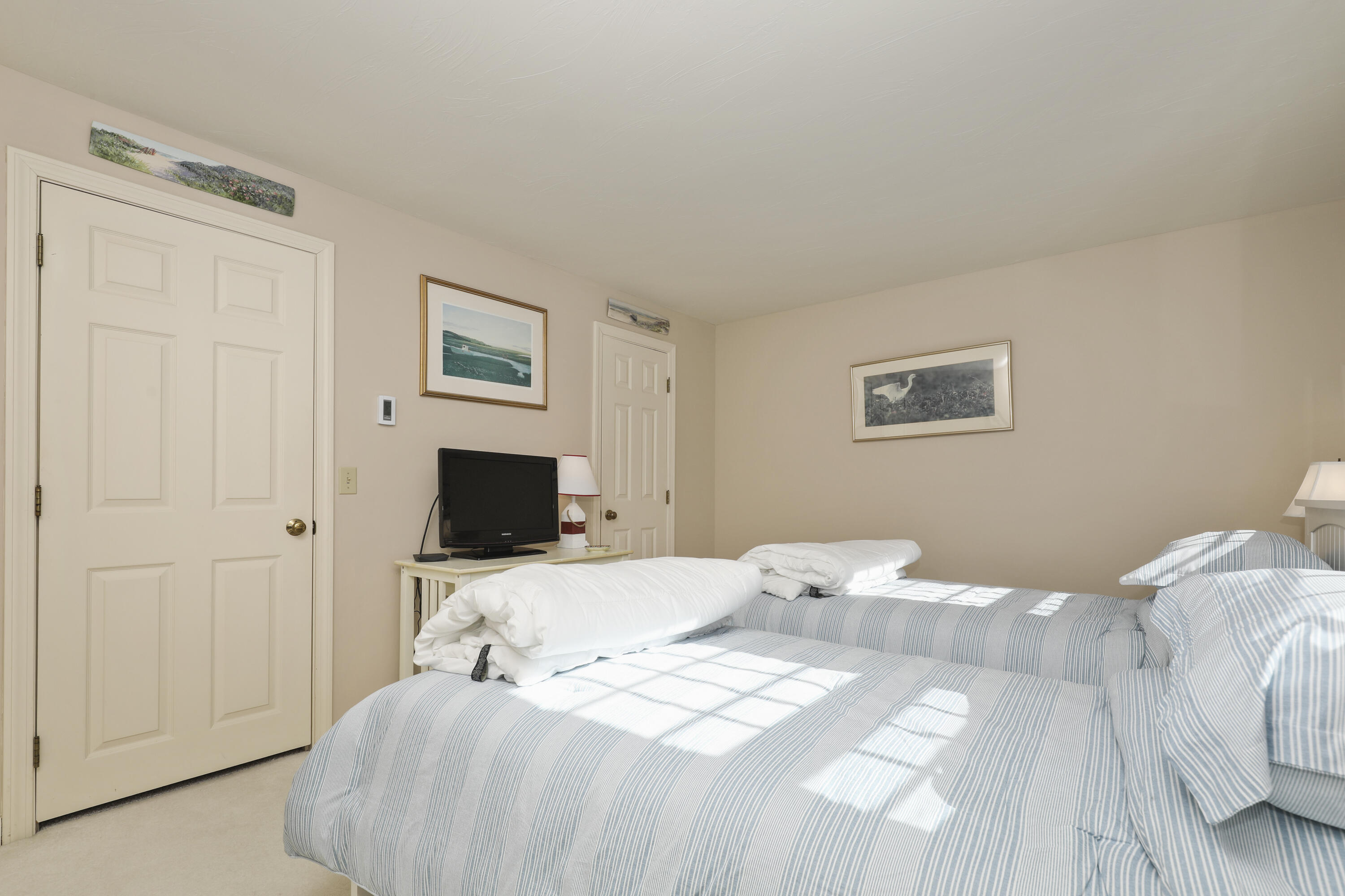 33 West Road, Unit 7B Orleans, MA 02653 - Photo 12 of 24 a bedroom with a bed and a tv