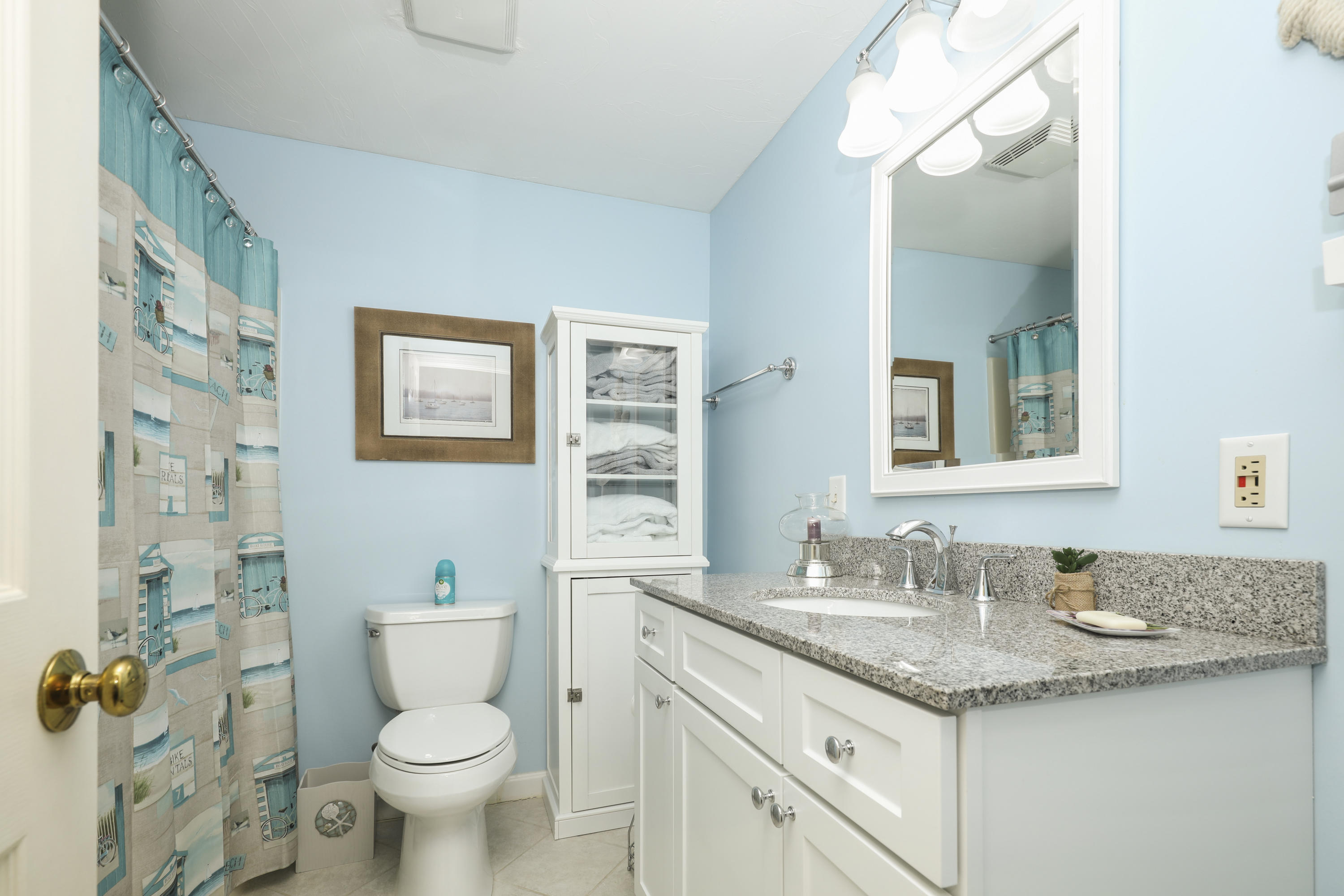 33 West Road, Unit 7B Orleans, MA 02653 - Photo 15 of 24 a bathroom with a granite countertop toilet sink and mirror