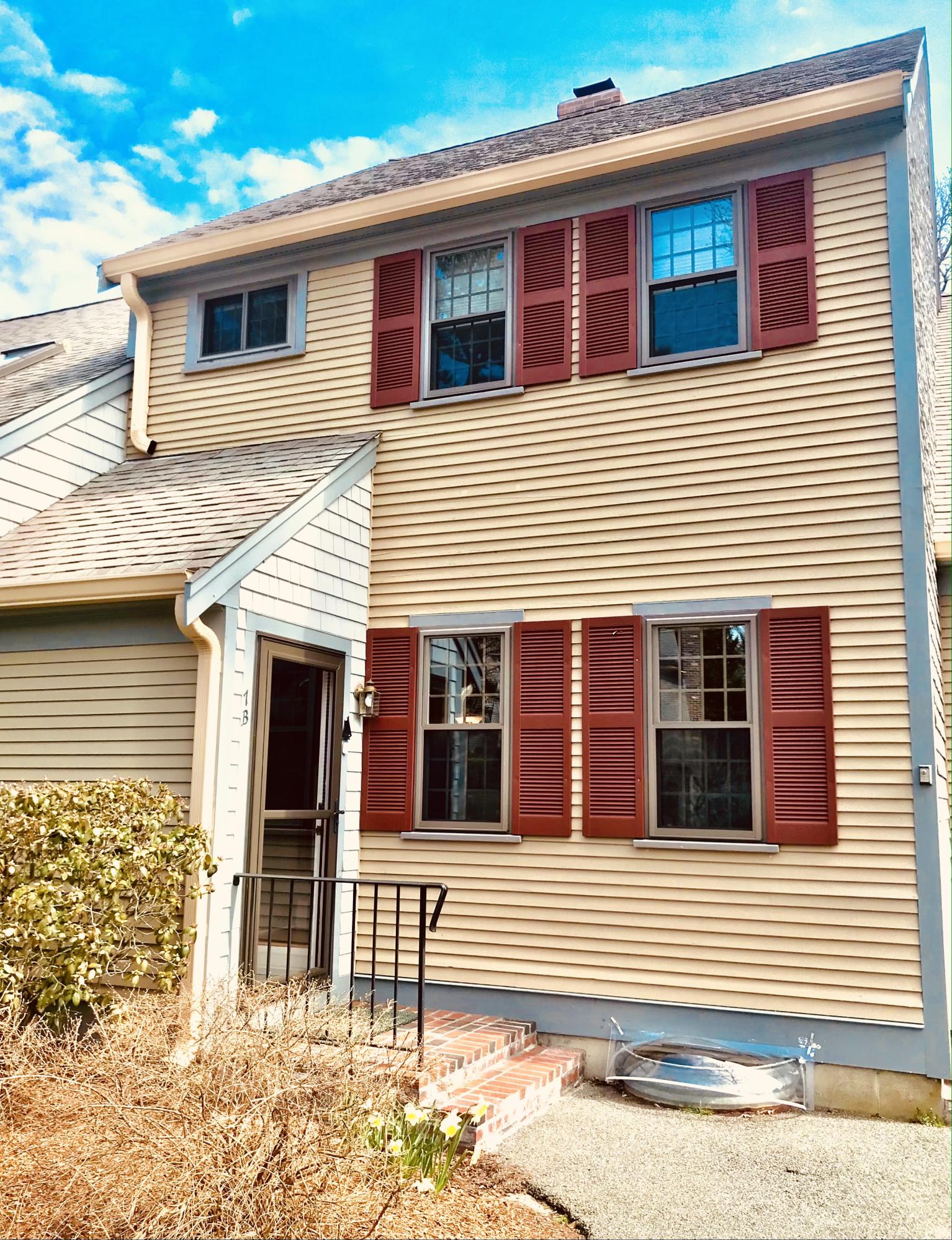 33 West Road, Unit 7B Orleans, MA 02653 - Photo 2 of 24 a front view of a house with a garage