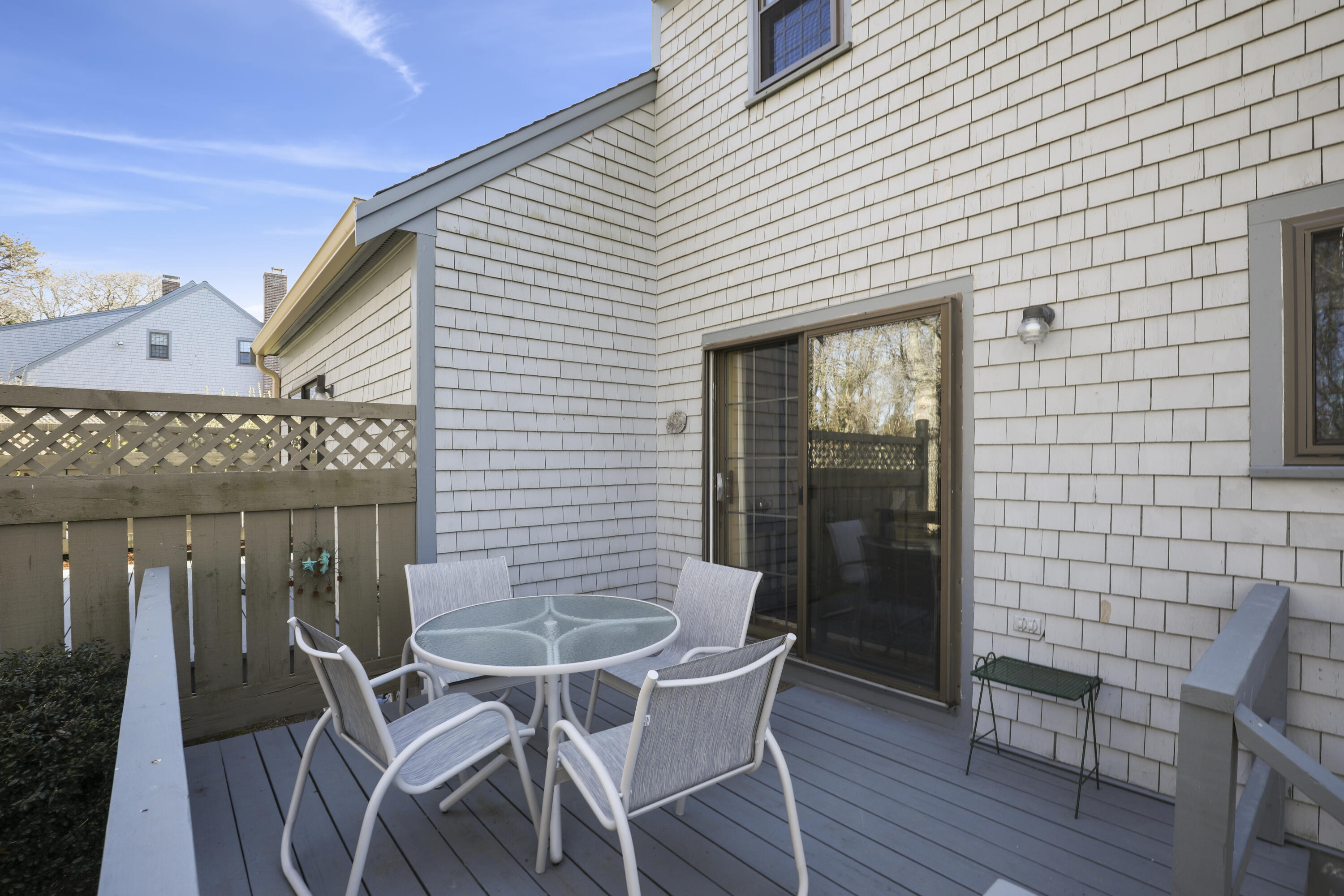 33 West Road, Unit 7B Orleans, MA 02653 - Photo 21 of 24 a patio with table and chairs and potted plants