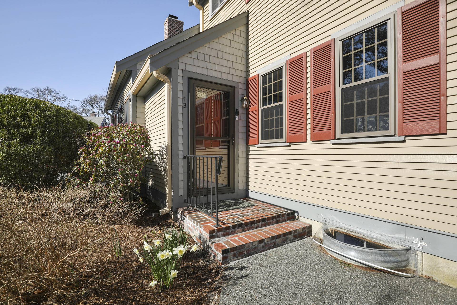33 West Road, Unit 7B Orleans, MA 02653 - Photo 3 of 24 a front view of a house with a garden