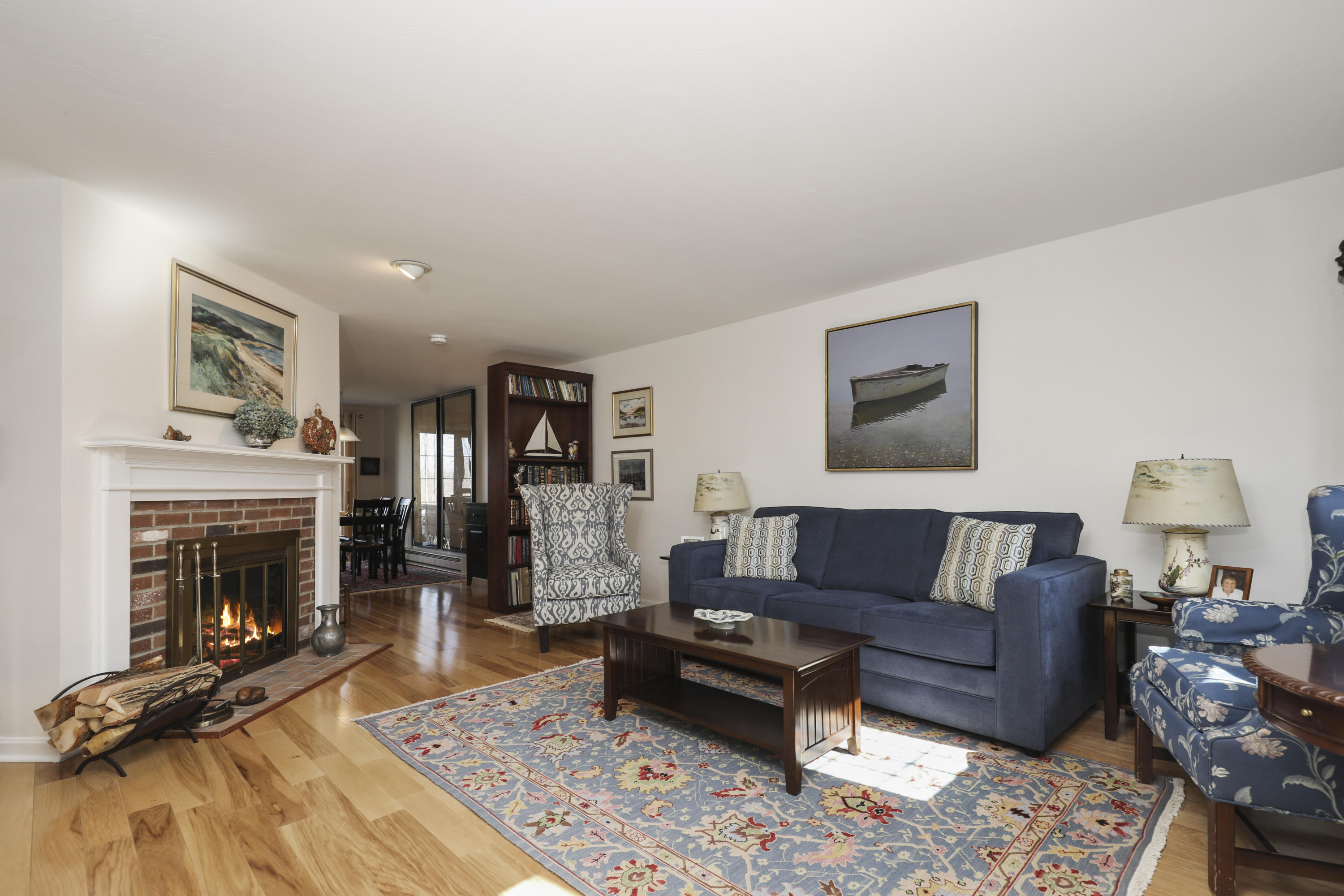33 West Road, Unit 7B Orleans, MA 02653 - Photo 4 of 24 a living room with furniture and a fireplace
