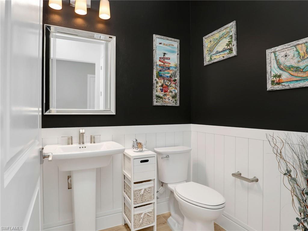 18412 Ridgeline Drive Estero, FL 33928 - Photo 35 of 50 a bathroom with a toilet sink and mirror