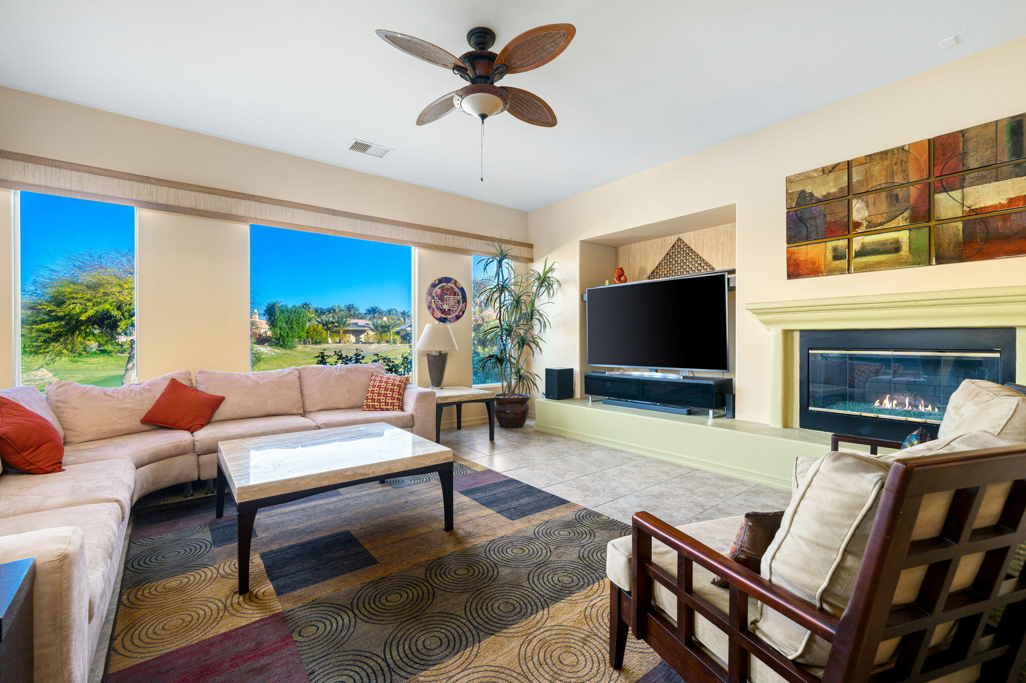 325 Loch Lomond Road Rancho Mirage, CA 92270 - Photo 24 of 49 a living room with furniture a flat screen tv and a fireplace