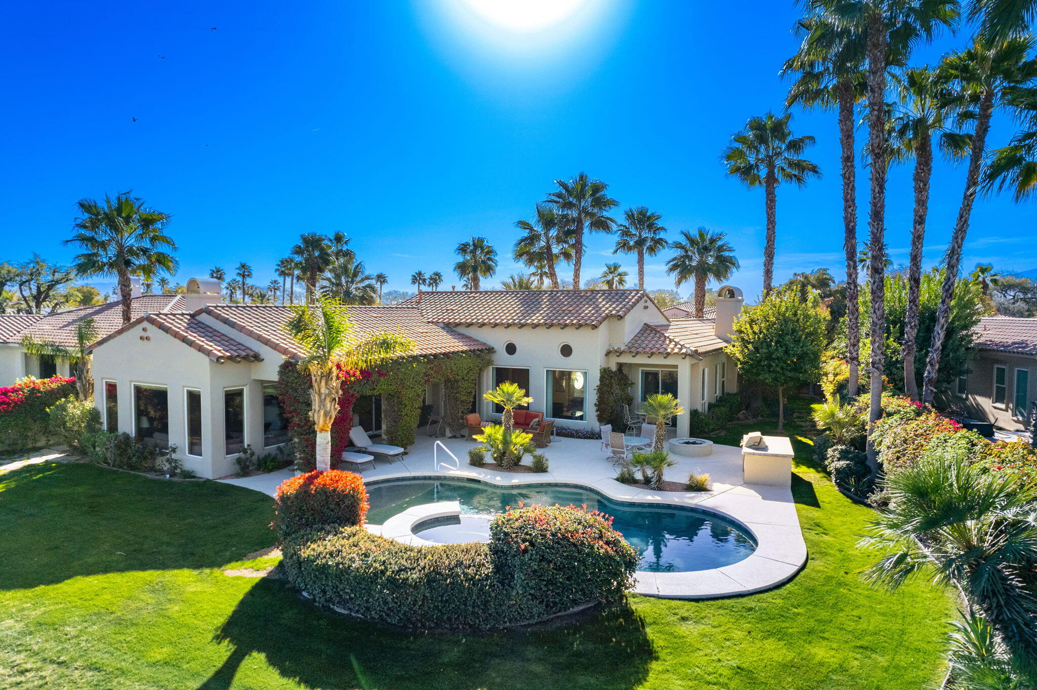 325 Loch Lomond Road Rancho Mirage, CA 92270 - Photo 3 of 49 a view of a house with swimming pool and a yard