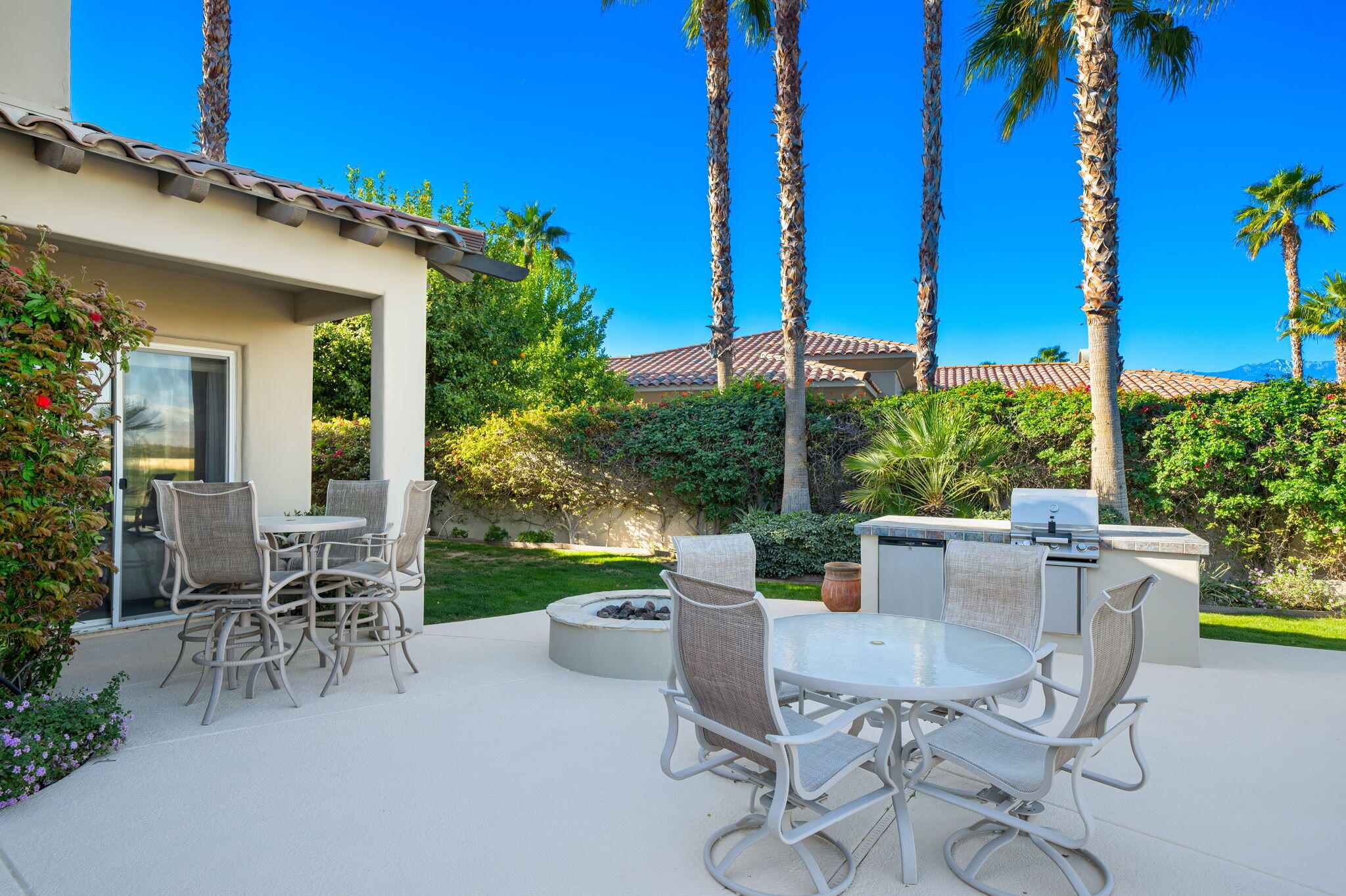 325 Loch Lomond Road Rancho Mirage, CA 92270 - Photo 35 of 49 a view of a patio with table and chairs potted plants and palm tree